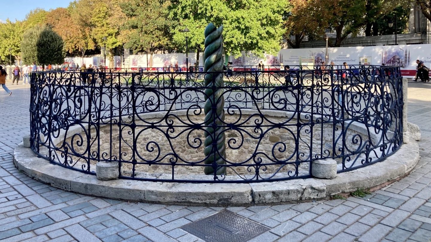 The bronze Serpent Column, its three intertwined snake bodies visible but missing their heads, standing in Istanbul's Sultanahmet Square