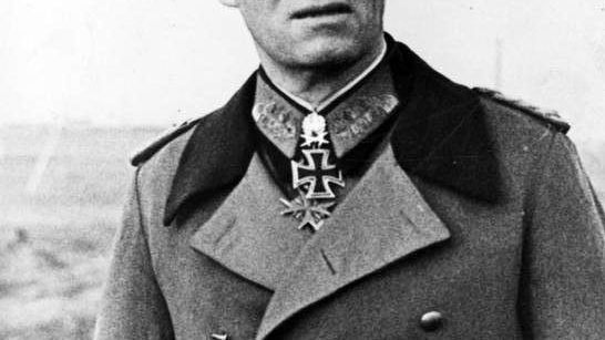 Formal portrait of Erwin Rommel in German military uniform and peaked cap, wearing the Pour le Mérite decoration at his collar