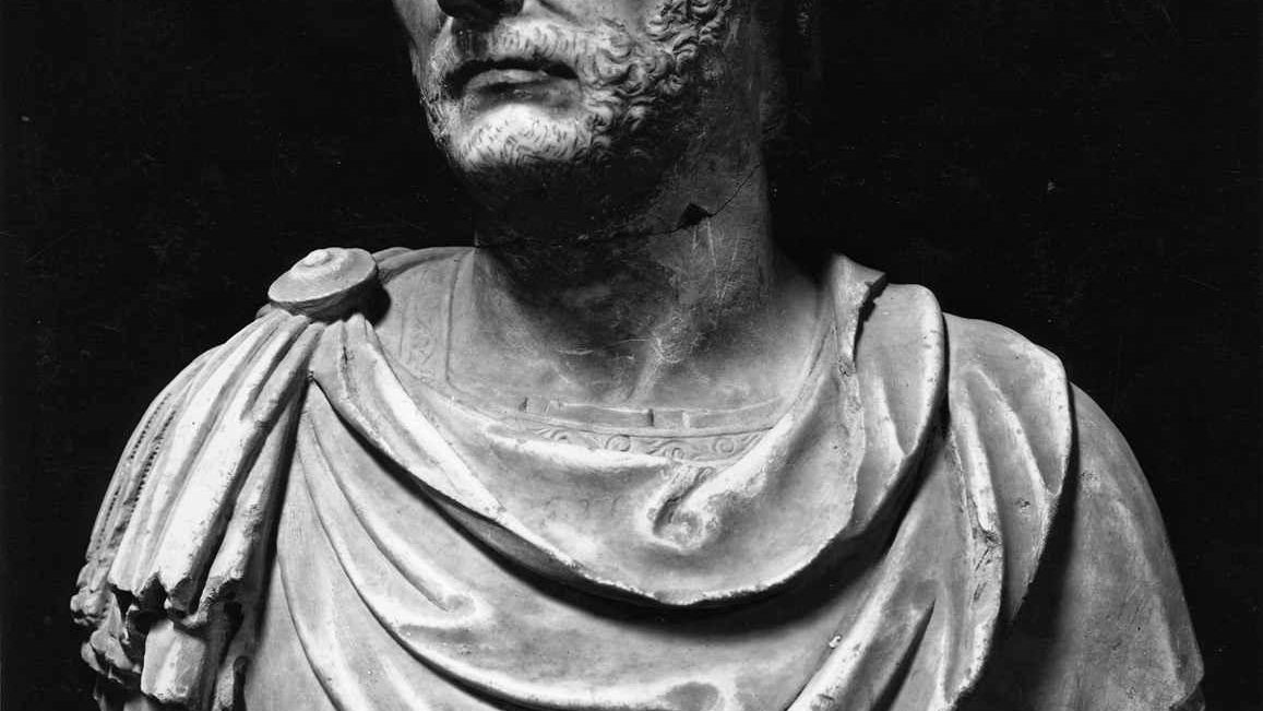 Photograph of a marble bust traditionally identified as Hannibal Barca, showing a bearded man wearing a patterned close-fitting cap, discovered at Capua and now held at the Quirinal Palace in Rome