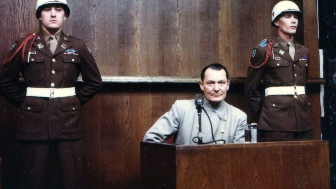 Color photograph of Hermann Göring under cross-examination in the witness box at his 1946 Nuremberg trial