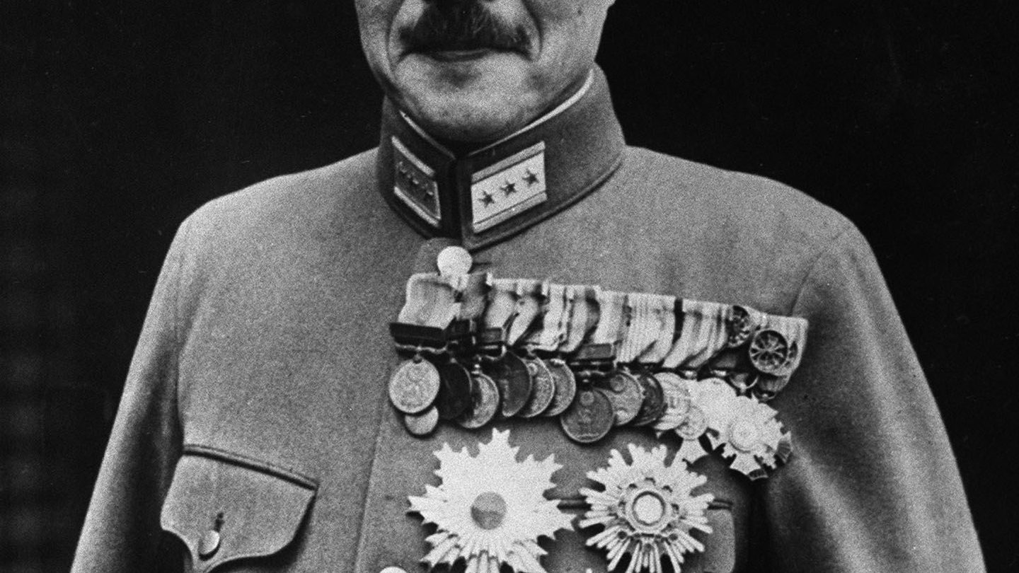 Formal 1941 portrait of Hideki Tojo in military uniform, his chest covered with rows of medals and star-shaped decorations