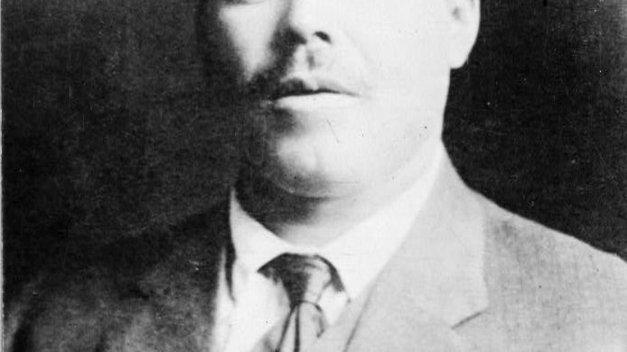 Portrait photograph of Pancho Villa in a suit and tie, circa 1910