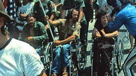 Ron Kovic and fellow Vietnam veteran protesters at the 1972 Republican National Convention in Miami, Florida, being filmed by a television camera crew